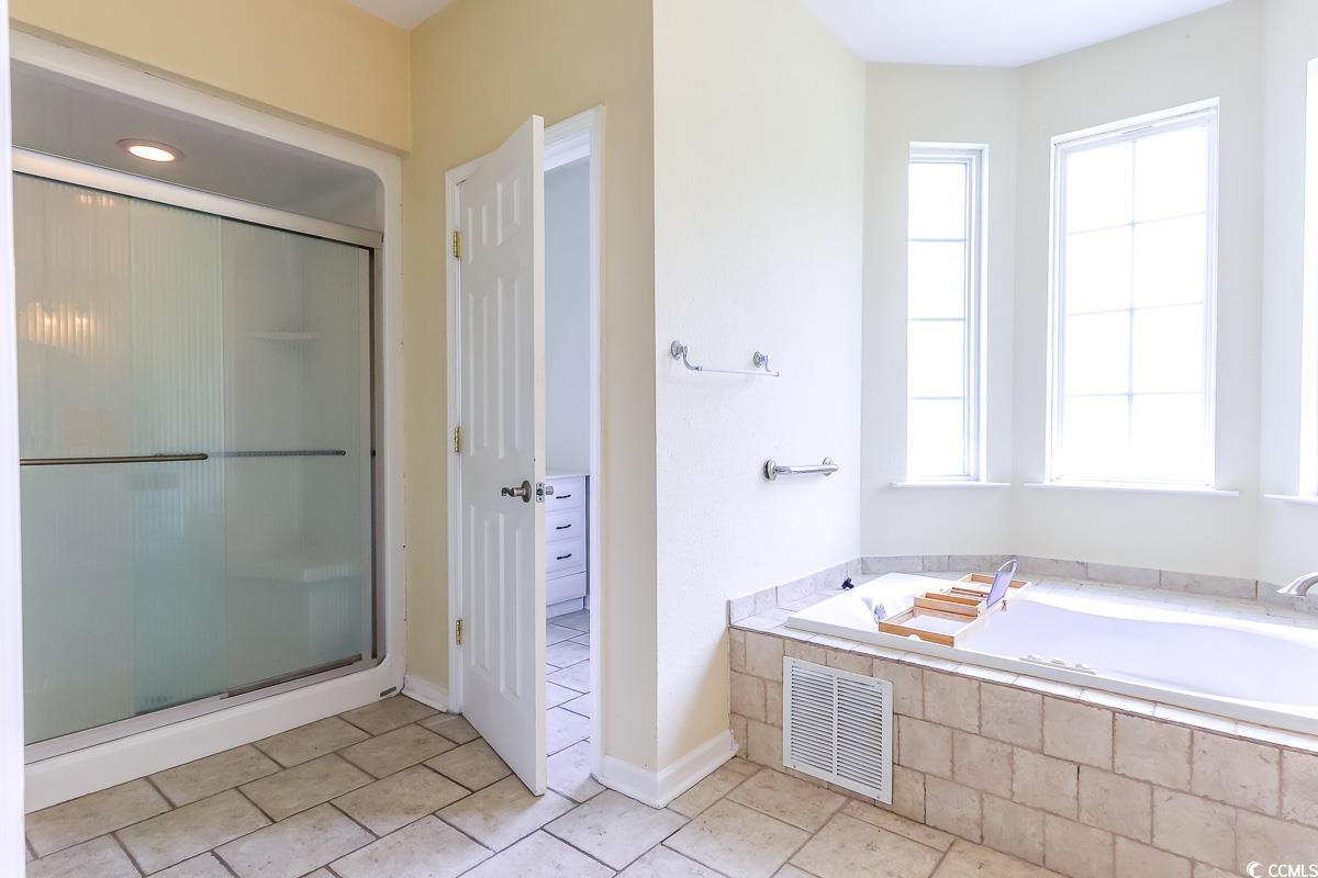 2191 Jasmine Road Loris, SC 29569 - Photo 17 of 40 Full bath featuring a garden tub, a stall shower, and tile patterned floors