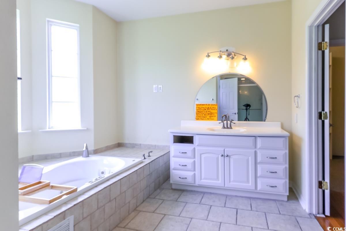 2191 Jasmine Road Loris, SC 29569 - Photo 18 of 40 Full bath featuring vanity, a bath, and tile patterned flooring