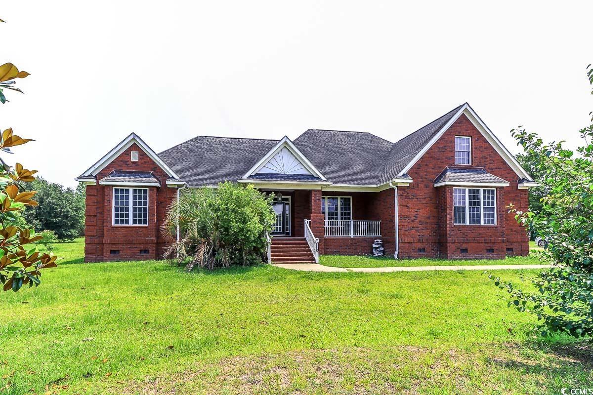 2191 Jasmine Road Loris, SC 29569 - Photo 2 of 40 View of front of property featuring crawl space, covered porch, brick siding, and a front yard