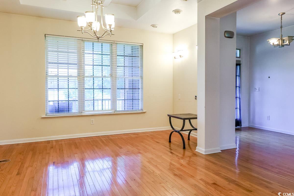 2191 Jasmine Road Loris, SC 29569 - Photo 21 of 40 Unfurnished room with a chandelier, hardwood / wood-style floors, and baseboards