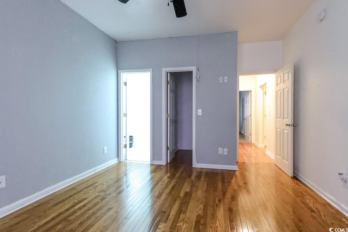 2191 Jasmine Road Loris, SC 29569 - Photo 26 of 40 Unfurnished bedroom with hardwood / wood-style flooring, a spacious closet, baseboards, ceiling fan, and a closet