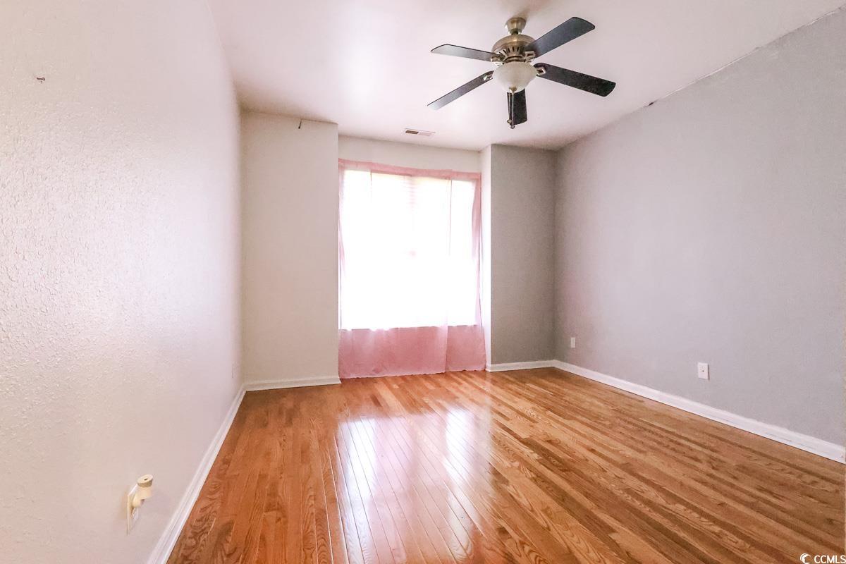 2191 Jasmine Road Loris, SC 29569 - Photo 27 of 40 Empty room with hardwood / wood-style floors, baseboards, and a ceiling fan
