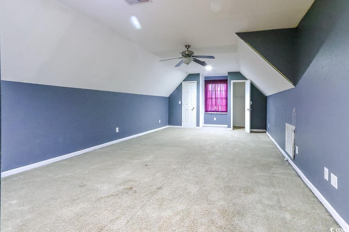 2191 Jasmine Road Loris, SC 29569 - Photo 28 of 40 Bonus room with baseboards, vaulted ceiling, a ceiling fan, and carpet flooring