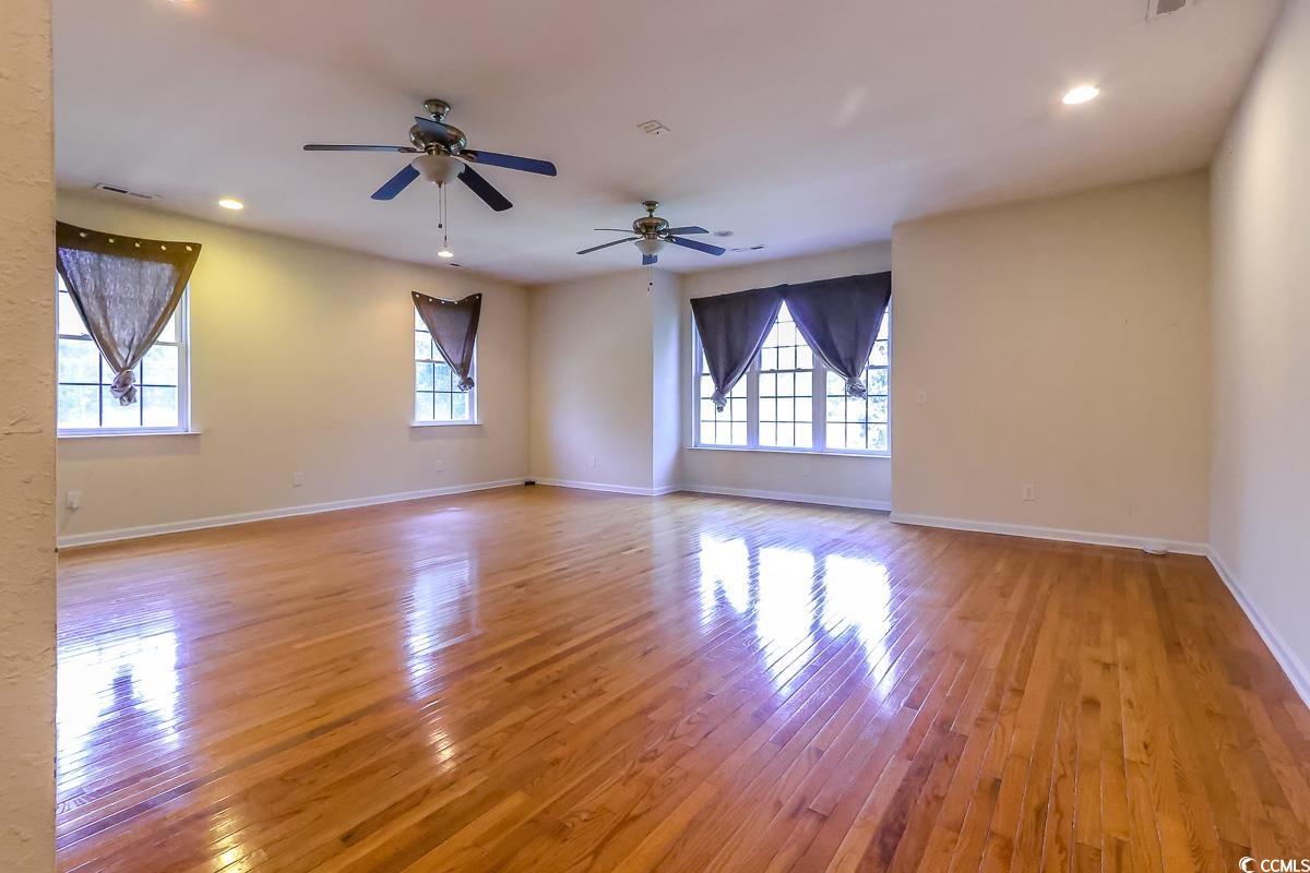 2191 Jasmine Road Loris, SC 29569 - Photo 30 of 40 Unfurnished room with healthy amount of natural light, light wood-type flooring, baseboards, recessed lighting, and ceiling fan