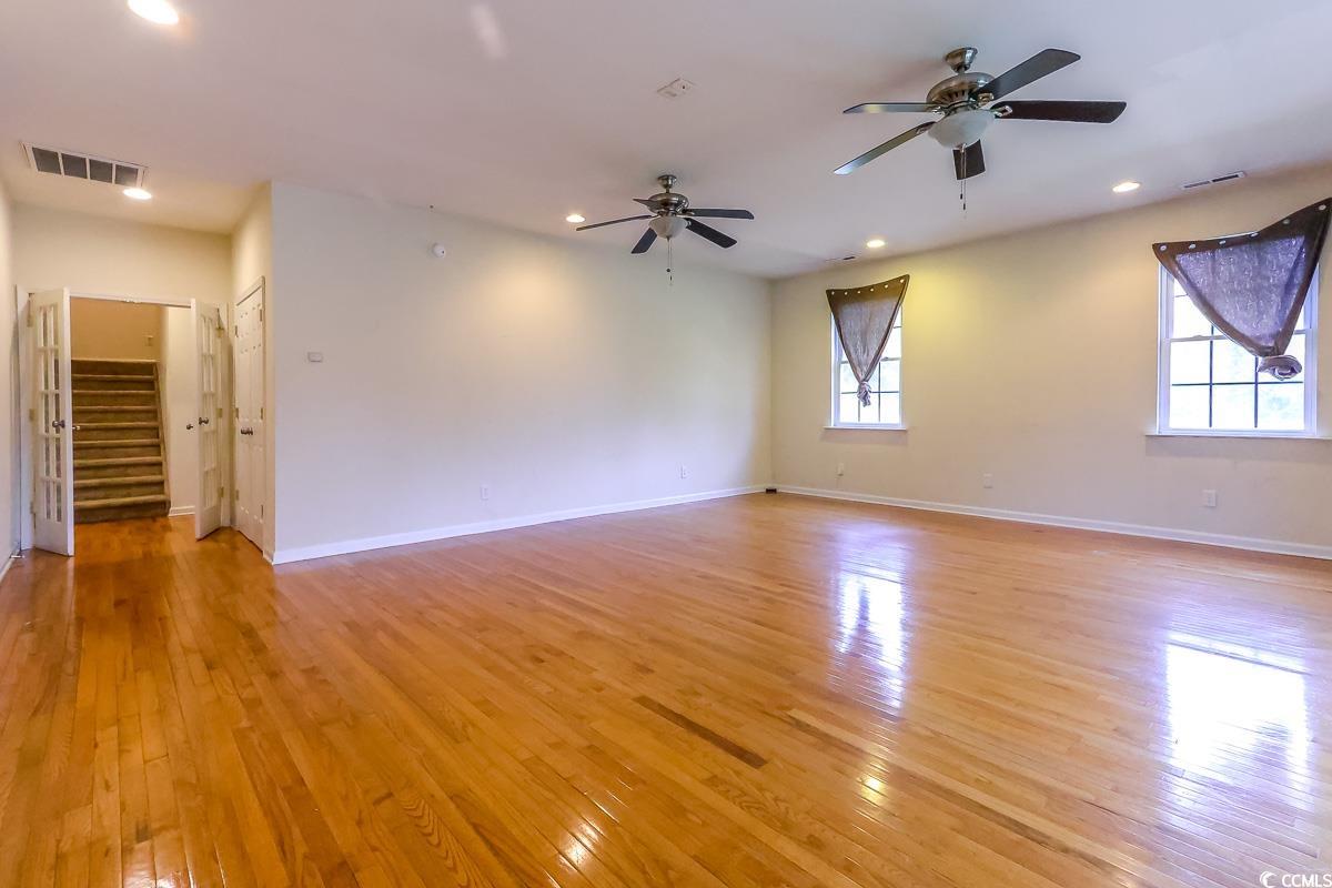2191 Jasmine Road Loris, SC 29569 - Photo 32 of 40 Unfurnished room featuring light wood finished floors, stairway, ceiling fan, baseboards, and recessed lighting