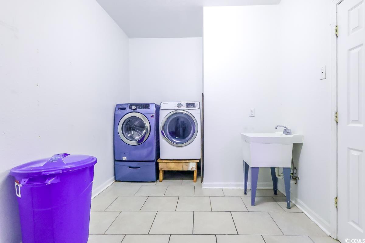2191 Jasmine Road Loris, SC 29569 - Photo 34 of 40 Laundry room with separate washer and dryer and baseboards