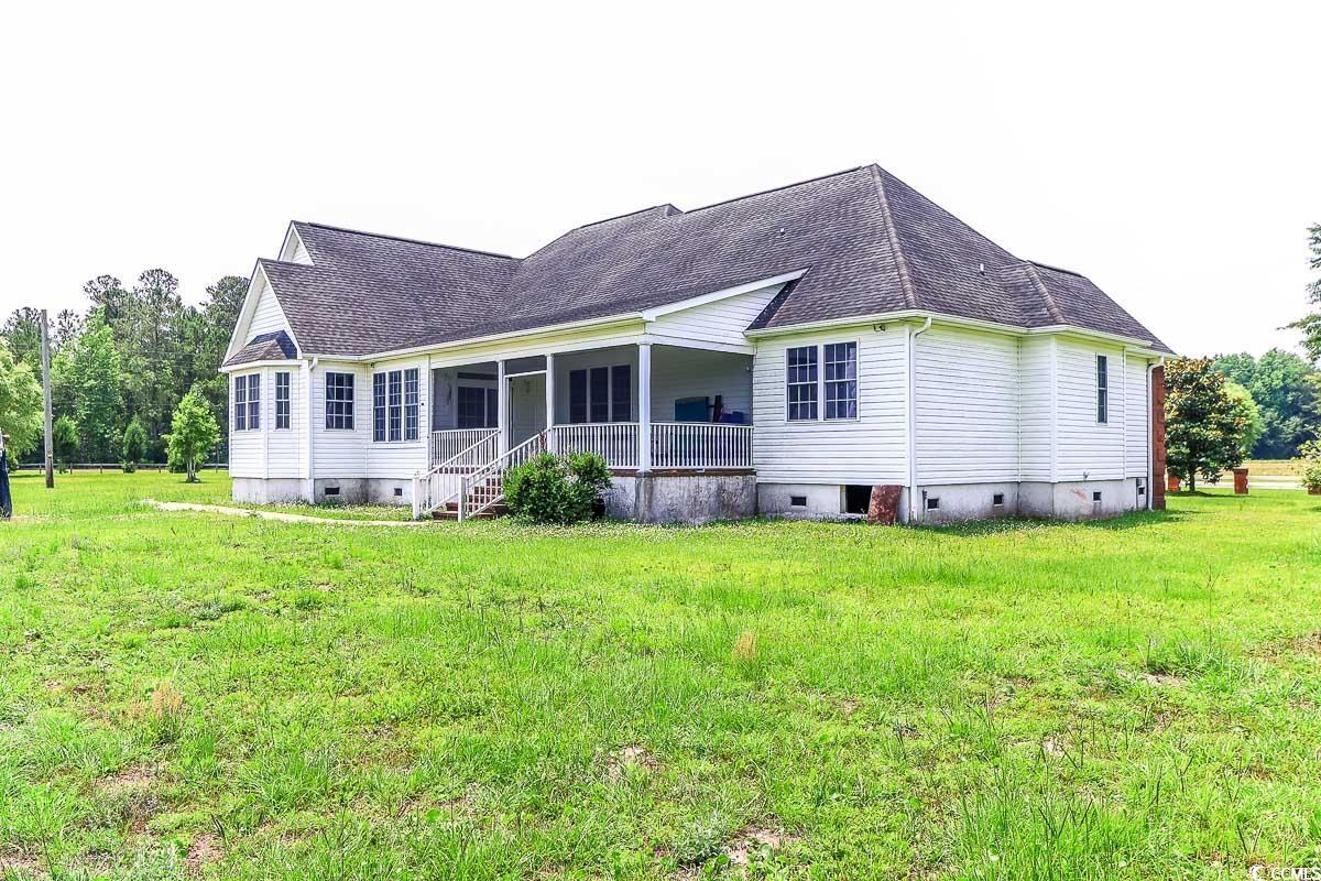 2191 Jasmine Road Loris, SC 29569 - Photo 36 of 40 Back of property featuring crawl space, a lawn, roof with shingles, and a porch