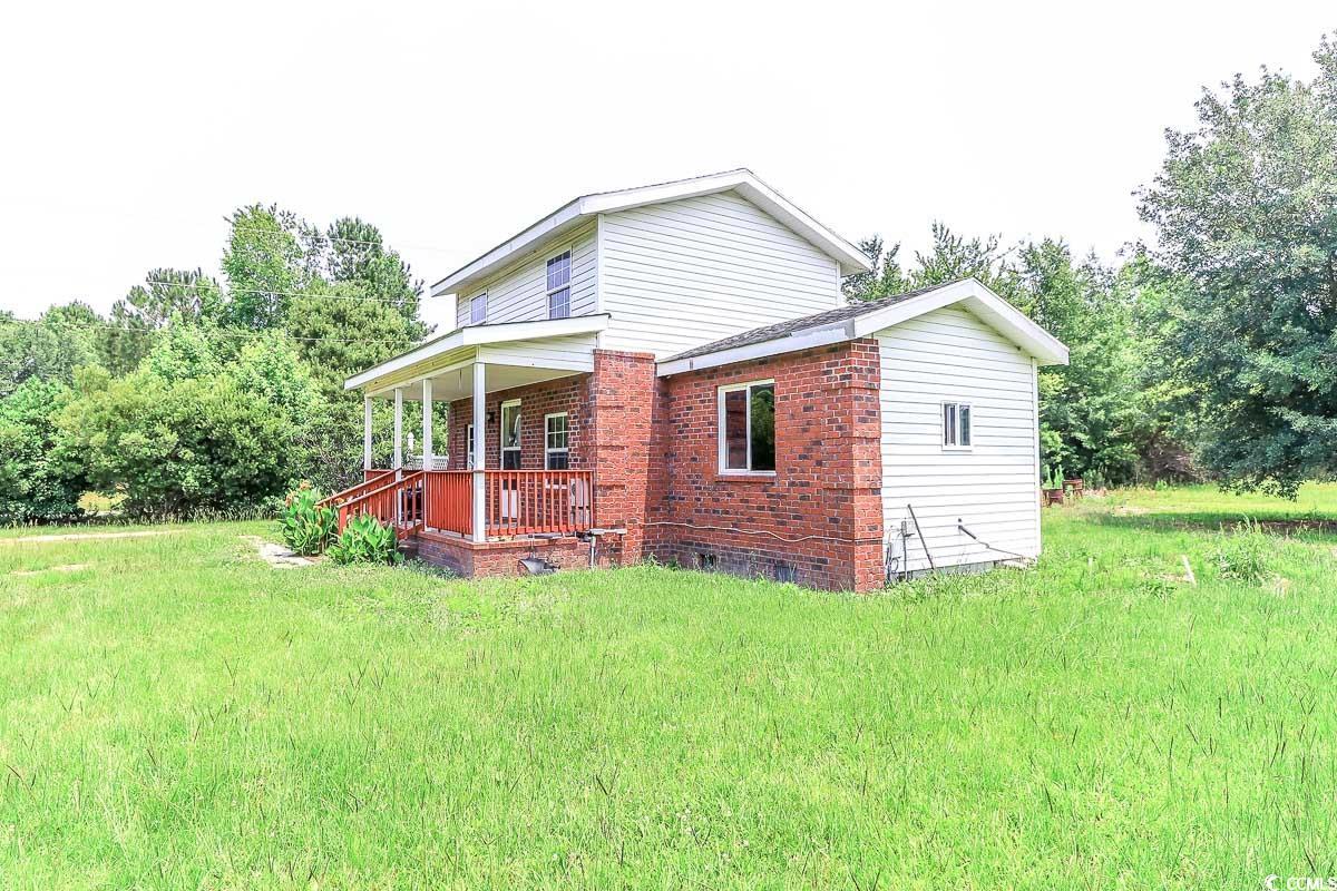 2191 Jasmine Road Loris, SC 29569 - Photo 38 of 40 Back of house featuring a porch, brick siding, a lawn, and crawl space
