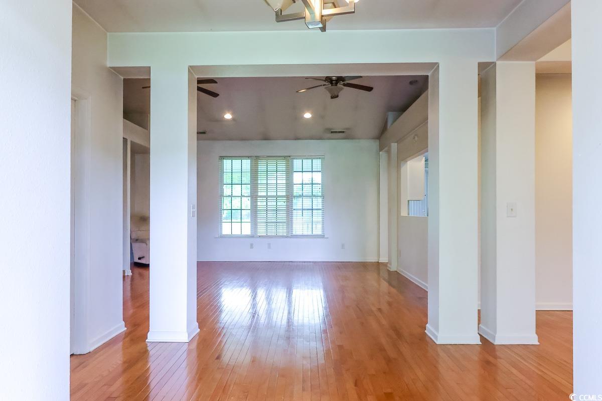 2191 Jasmine Road Loris, SC 29569 - Photo 5 of 40 Spare room featuring ceiling fan, light wood-style flooring, and baseboards