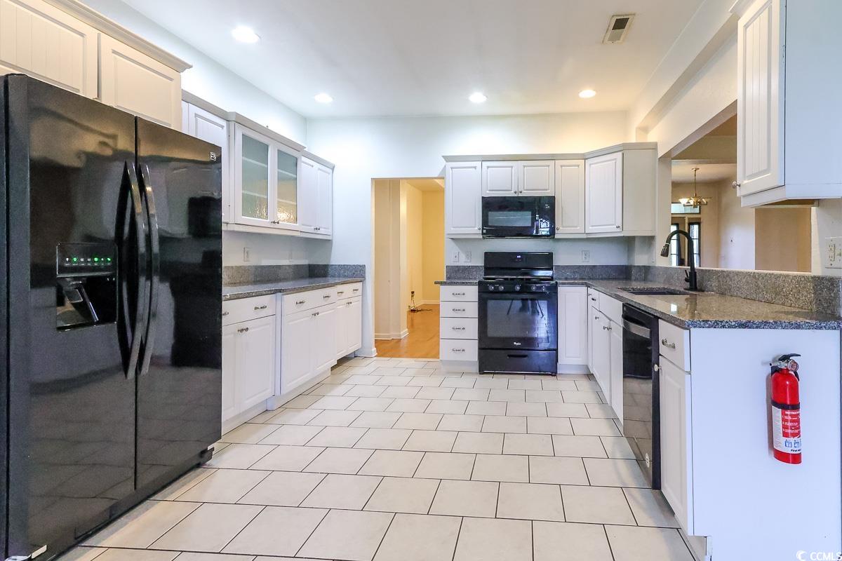 2191 Jasmine Road Loris, SC 29569 - Photo 8 of 40 Kitchen featuring black appliances, a sink, glass insert cabinets, recessed lighting, and white cabinets