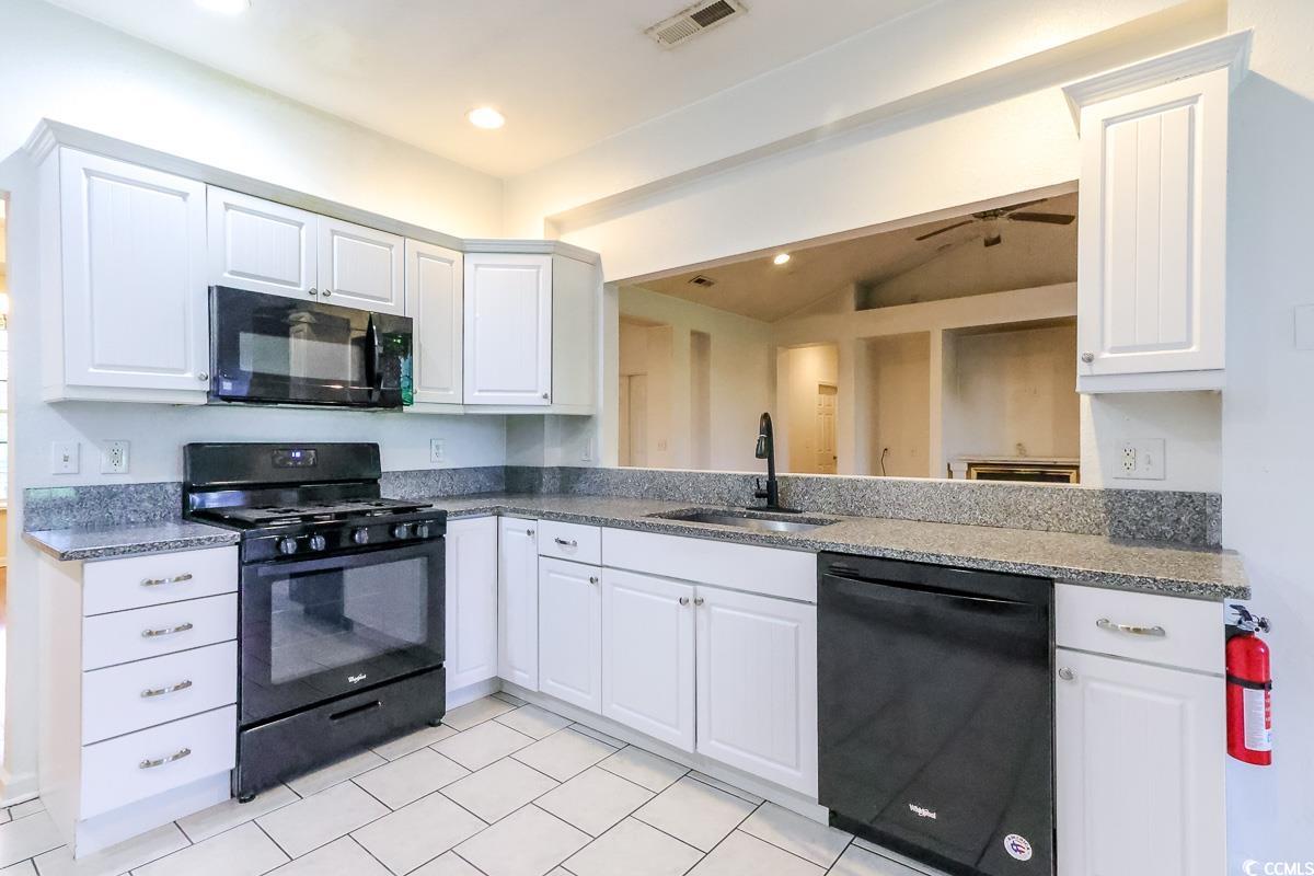 2191 Jasmine Road Loris, SC 29569 - Photo 9 of 40 Kitchen featuring black appliances, a sink, white cabinets, dark stone counters, and recessed lighting