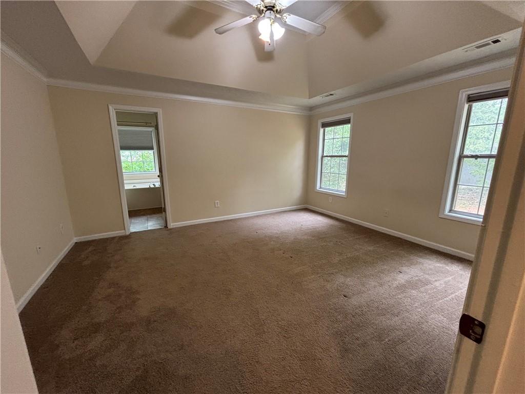 170 Gibson Way Covington, GA 30016 - Photo 14 of 50 an empty room with windows and fan