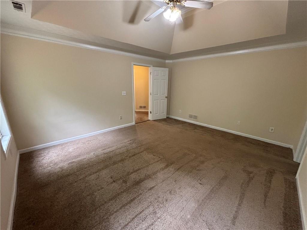 170 Gibson Way Covington, GA 30016 - Photo 15 of 50 an empty room with a chandelier fan