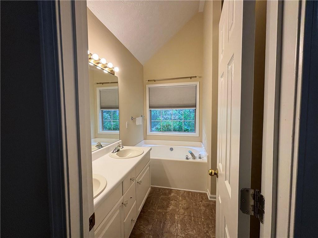 170 Gibson Way Covington, GA 30016 - Photo 17 of 50 a bathroom with a tub sink and mirror