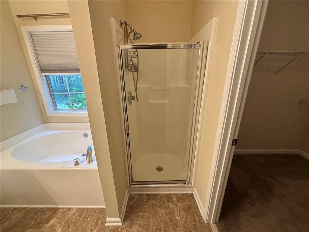 170 Gibson Way Covington, GA 30016 - Photo 19 of 50 a bathroom with a tub and a shower