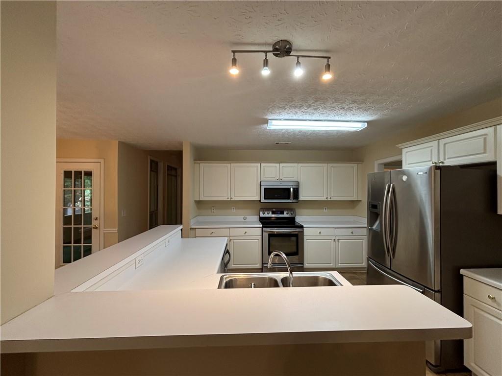 170 Gibson Way Covington, GA 30016 - Photo 34 of 50 a kitchen with kitchen island a sink stainless steel appliances and window