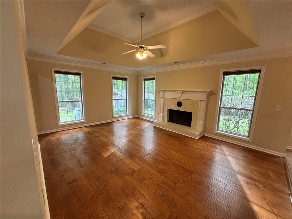 170 Gibson Way Covington, GA 30016 - Photo 43 of 50 an empty room with wooden floor fireplace and windows