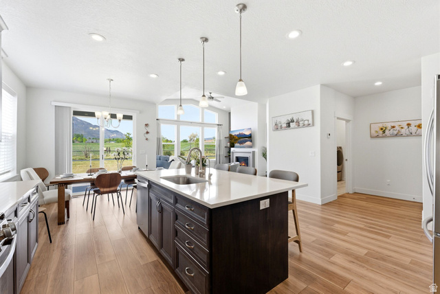 108 West Monte Rosa Lane Midway, UT 84049 - Photo 3 of 48 Open-concept interior featuring wood-finish flooring, recessed lighting, and a kitchen island with seating