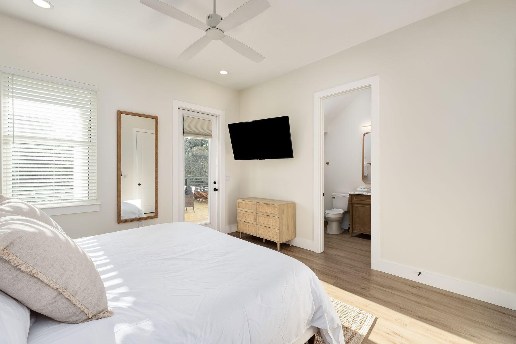 221 Hillcrest Road Santa Rosa Beach, FL 32459 - Photo 16 of 52 a bedroom with a bed and a flat screen tv