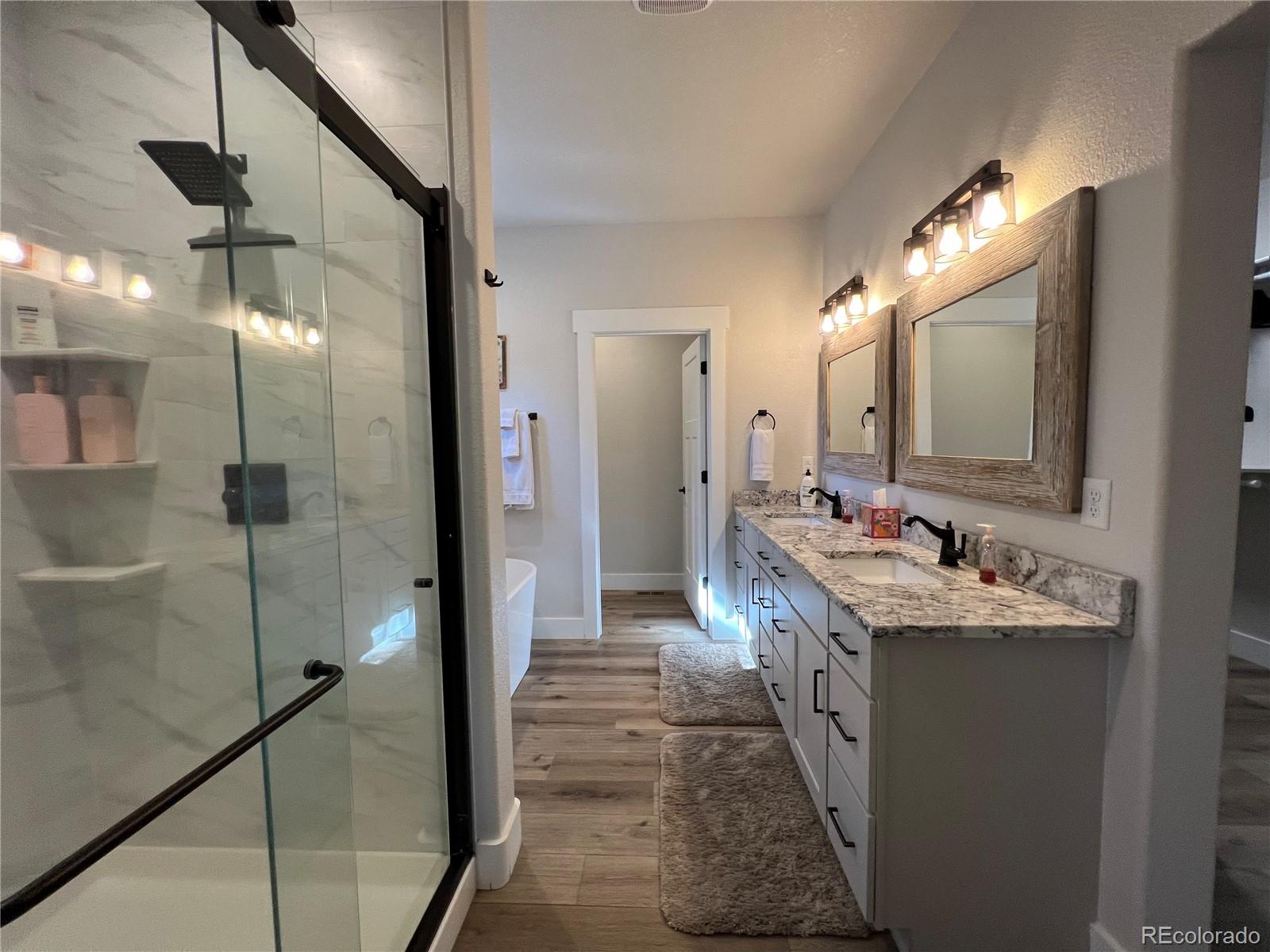 348 Duesouth Road Florissant, CO 80816 - Photo 14 of 28 a bathroom with a double vanity sink mirror and shower