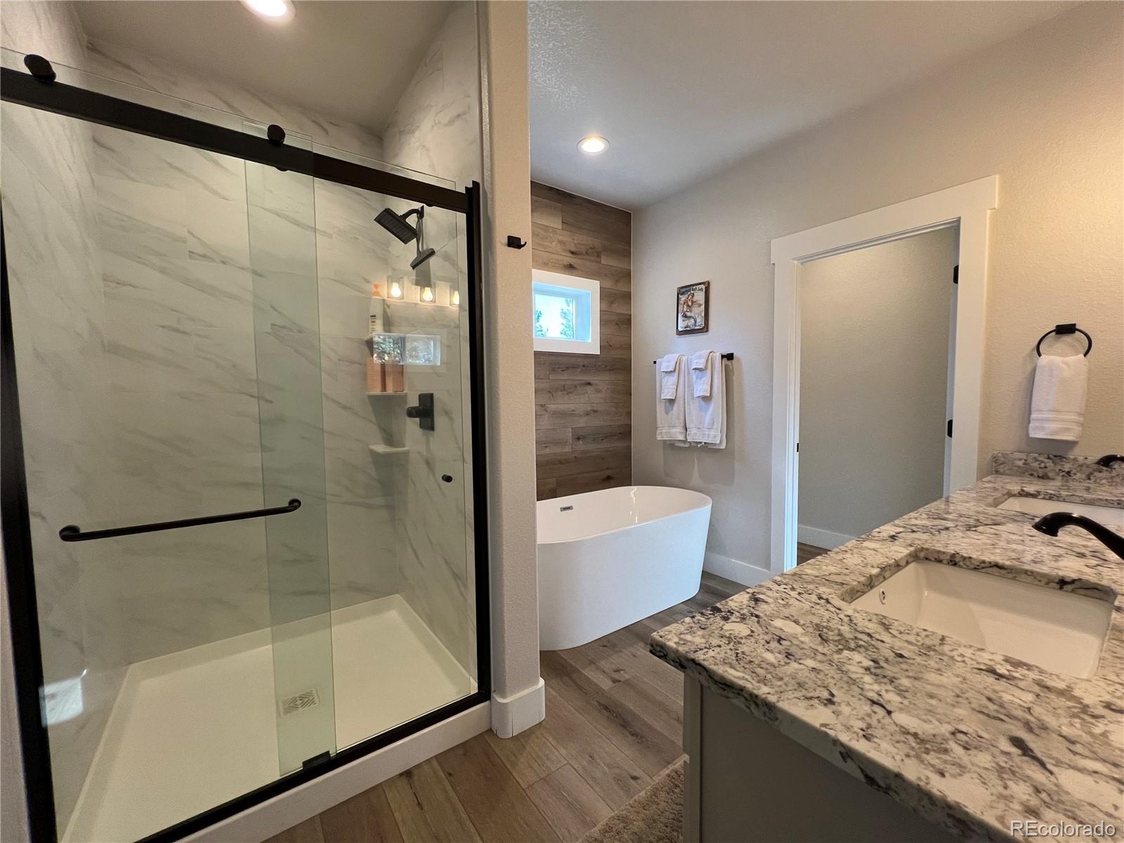 348 Duesouth Road Florissant, CO 80816 - Photo 15 of 28 a bathroom with a granite countertop bathtub shower sink and mirror