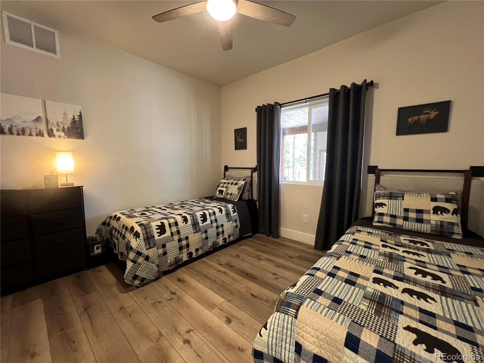 348 Duesouth Road Florissant, CO 80816 - Photo 18 of 28 a bedroom with a bed and window