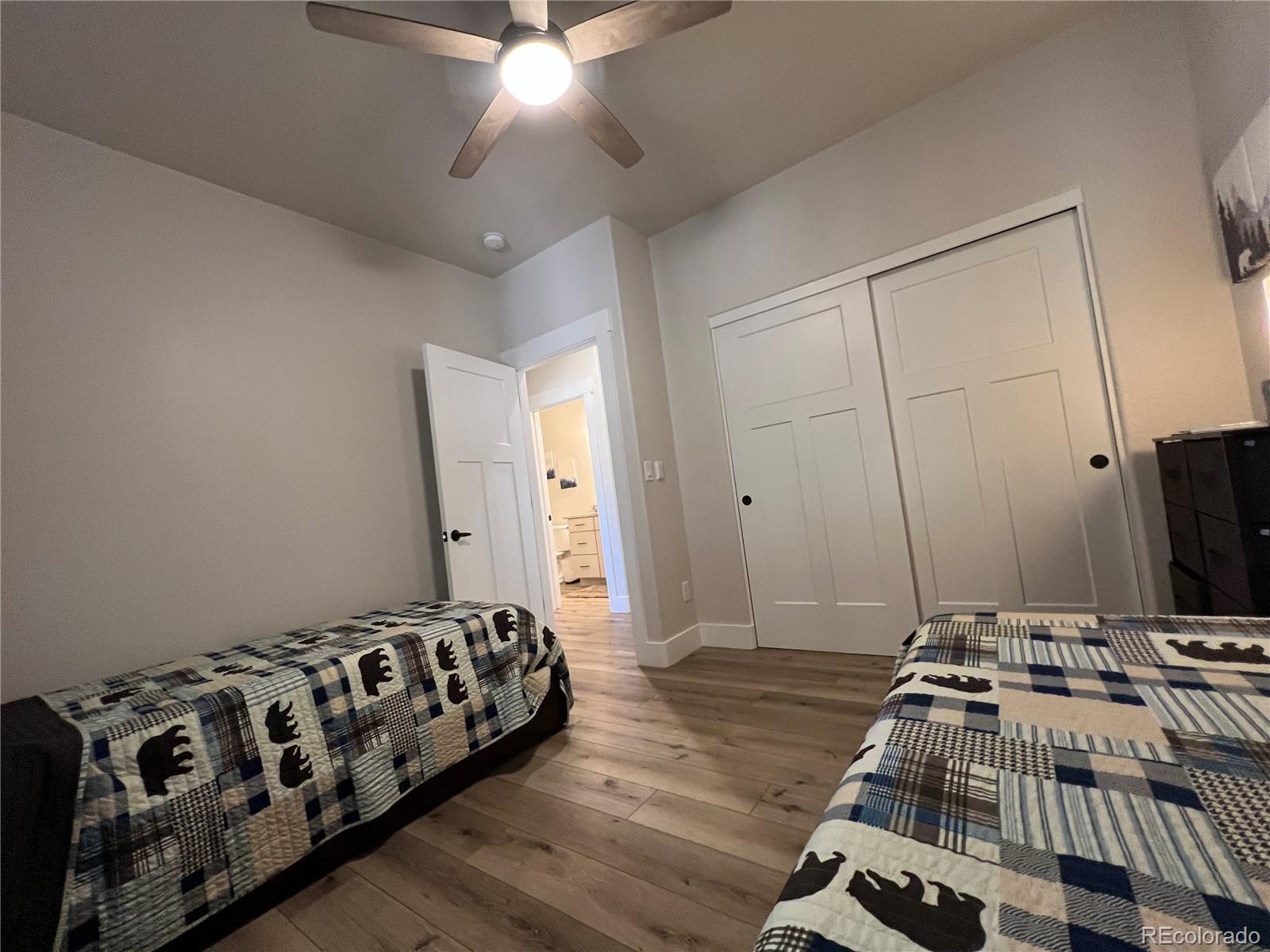 348 Duesouth Road Florissant, CO 80816 - Photo 19 of 28 a bedroom with a bed and a chandelier