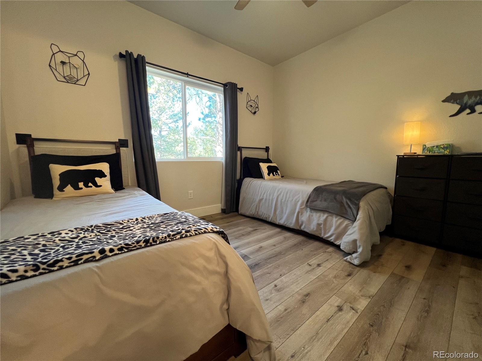 348 Duesouth Road Florissant, CO 80816 - Photo 20 of 28 a bedroom with a bed and a window