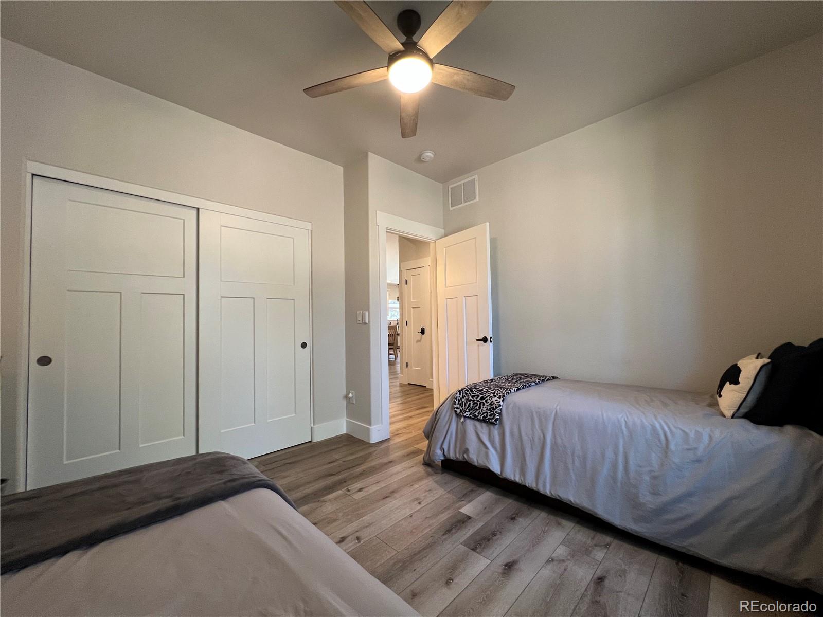 348 Duesouth Road Florissant, CO 80816 - Photo 21 of 28 a bedroom with a bed and a ceiling fan