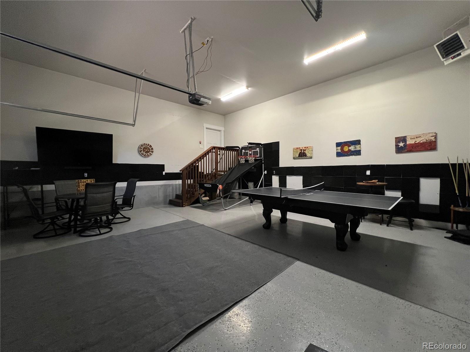 348 Duesouth Road Florissant, CO 80816 - Photo 27 of 28 a living room with furniture a rug and a flat screen tv