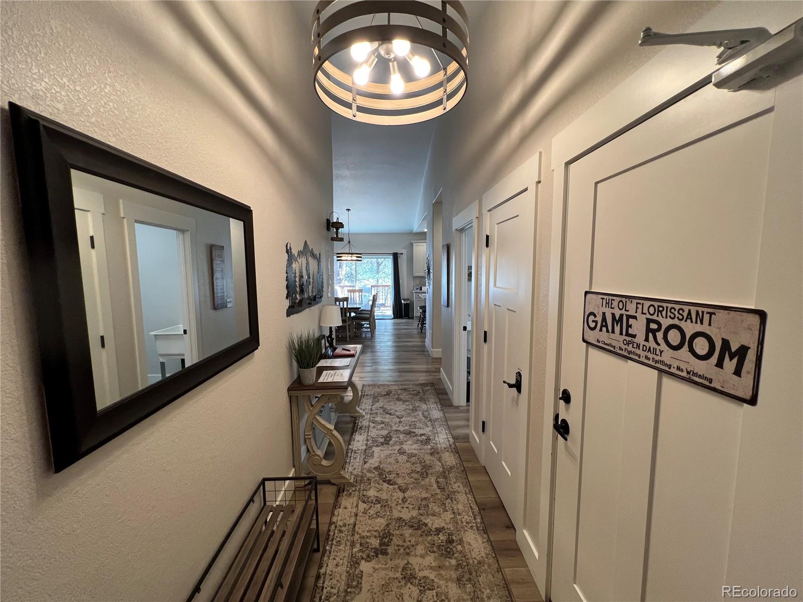 348 Duesouth Road Florissant, CO 80816 - Photo 3 of 28 a view of a hallway with wooden floor and staircase