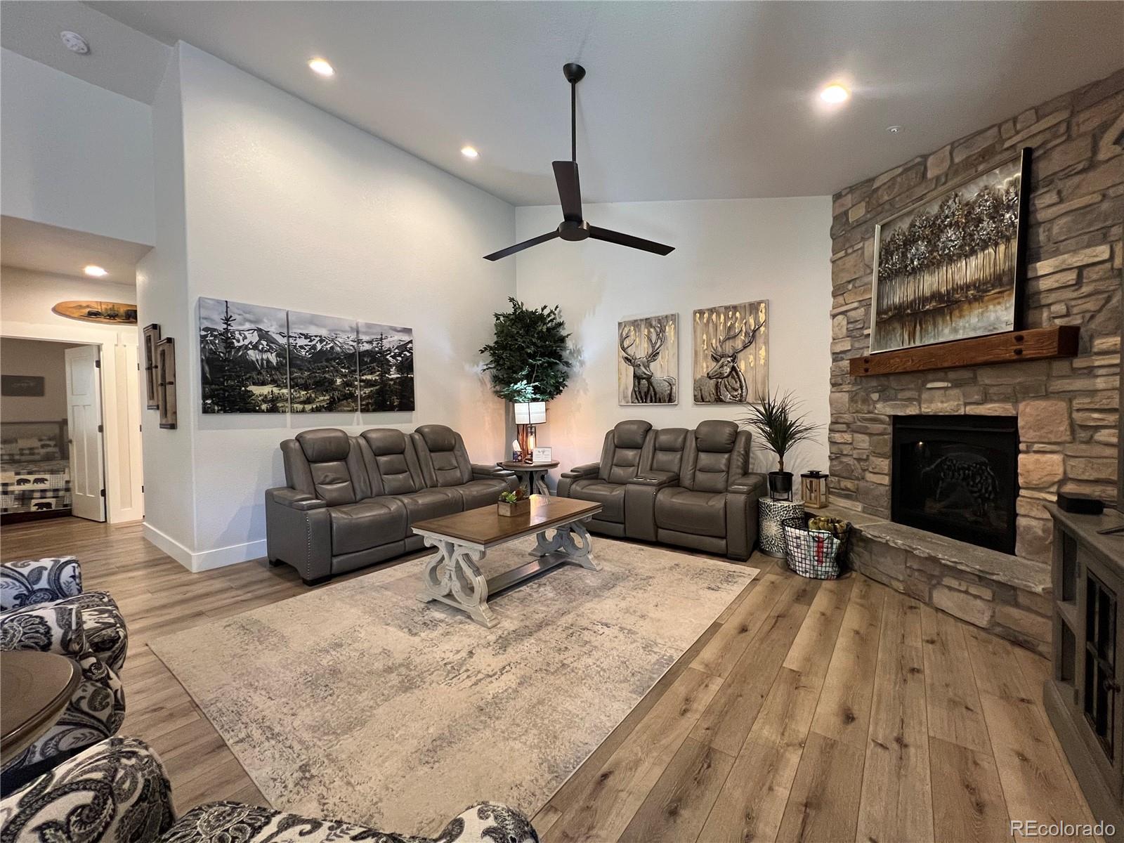 348 Duesouth Road Florissant, CO 80816 - Photo 6 of 28 a living room with furniture a fireplace and a flat screen tv