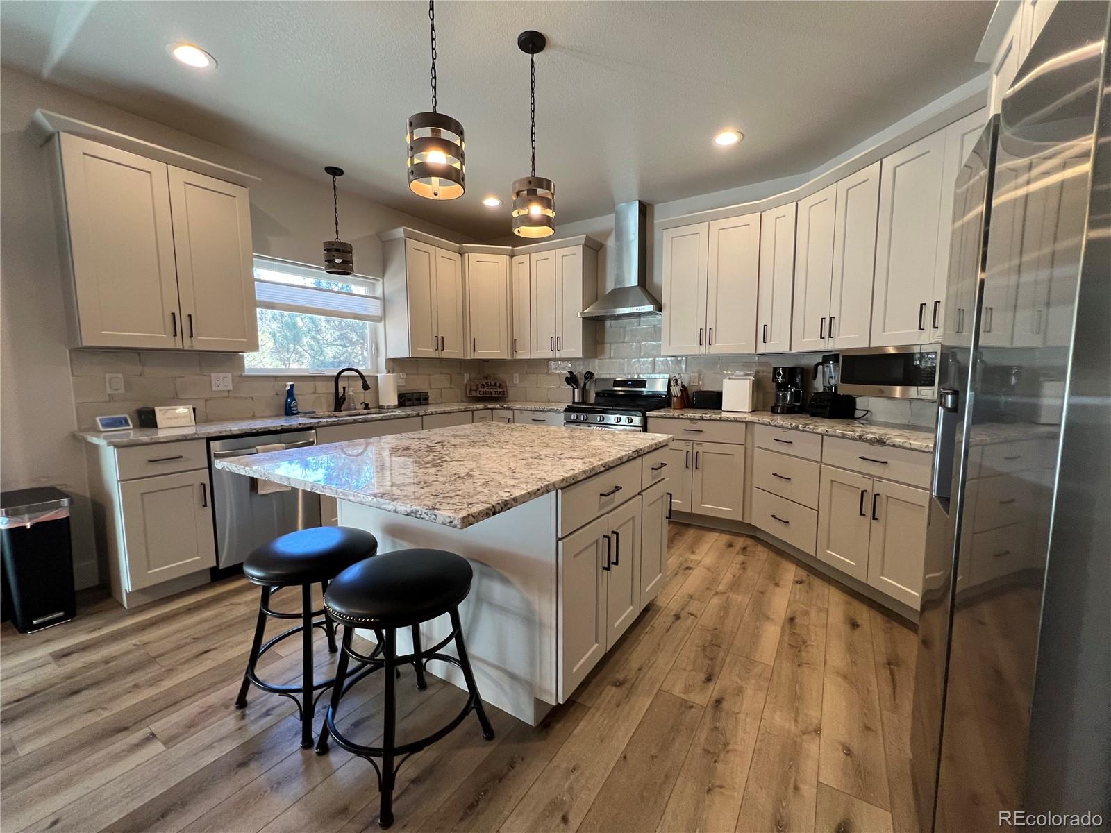 348 Duesouth Road Florissant, CO 80816 - Photo 10 of 28 a kitchen with kitchen island granite countertop a sink a counter space appliances and cabinets