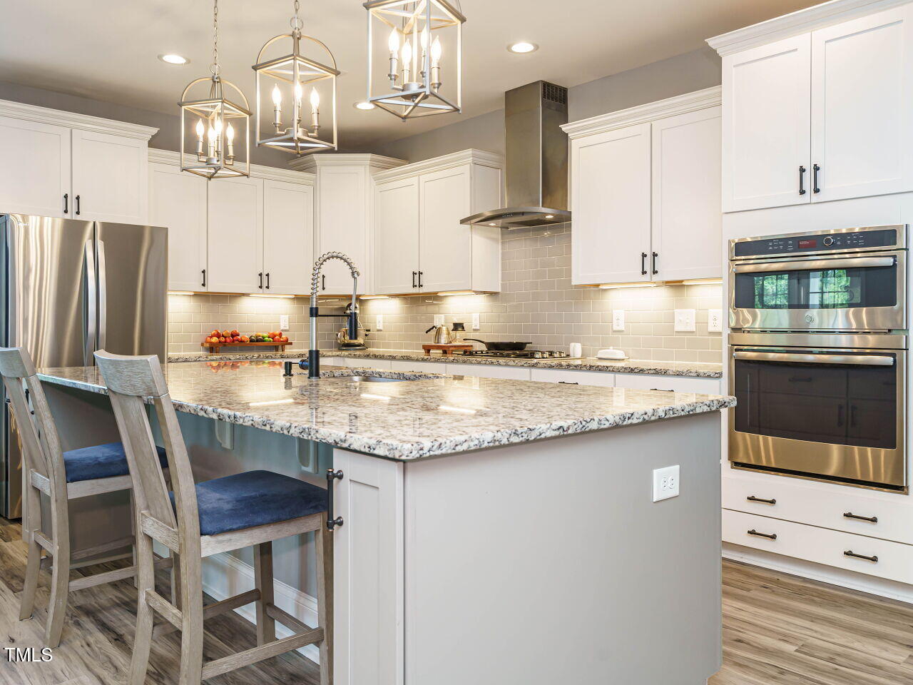 2909 Thurman Dairy Loop Wake Forest, NC 27587 - Photo 6 of 46 a kitchen with granite countertop a table chairs stove and cabinets
