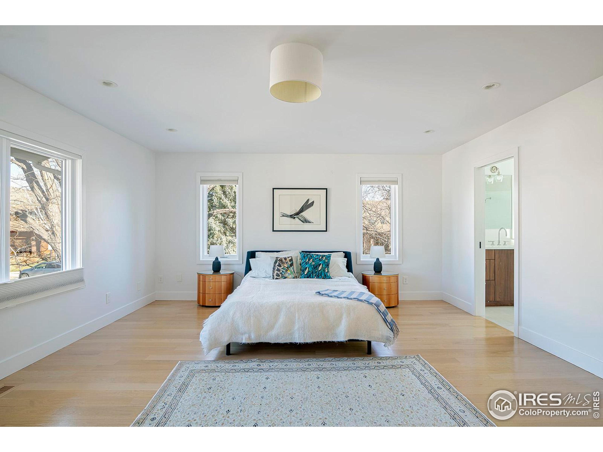 1707 Grape Avenue Boulder, CO 80304 - Photo 13 of 35 a bedroom with a bed and wooden floor