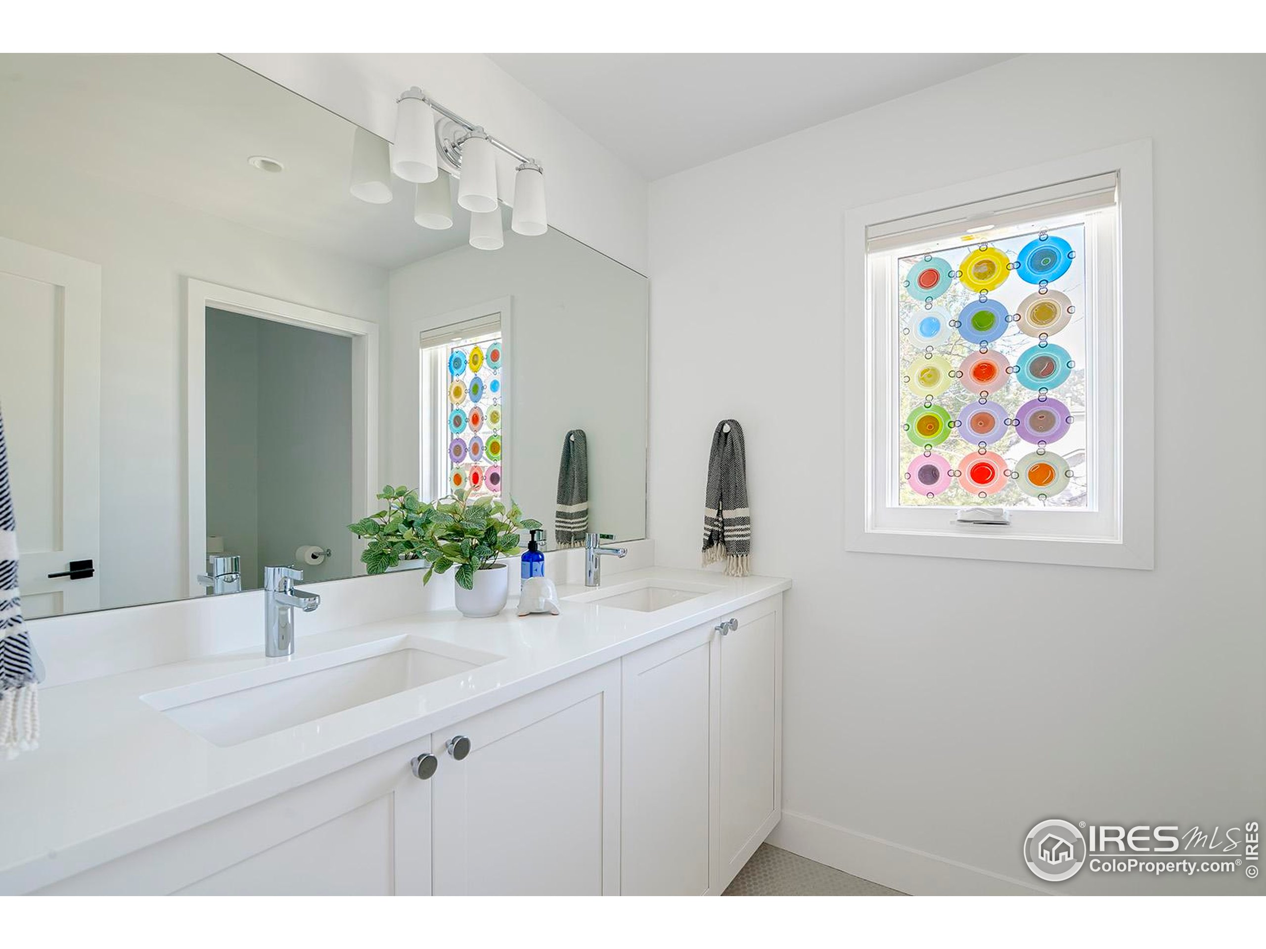 1707 Grape Avenue Boulder, CO 80304 - Photo 24 of 35 a bathroom with a sink a vanity and a mirror
