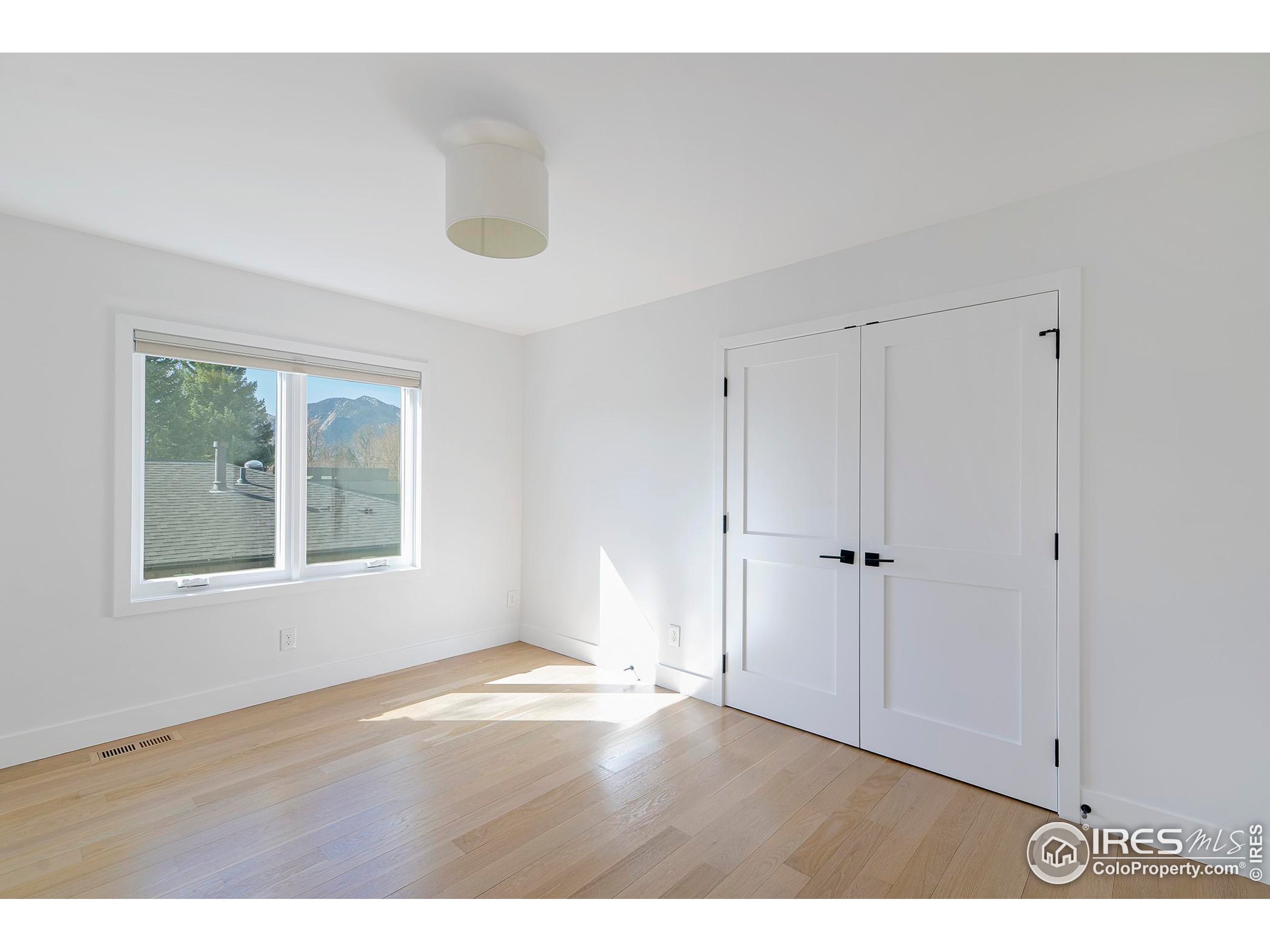 1707 Grape Avenue Boulder, CO 80304 - Photo 25 of 35 a view of an empty room with wooden floor and a window