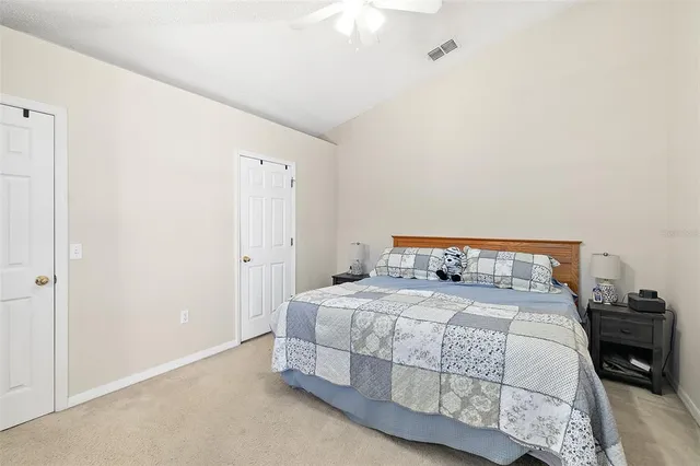 a bedroom with a bed and a night stand