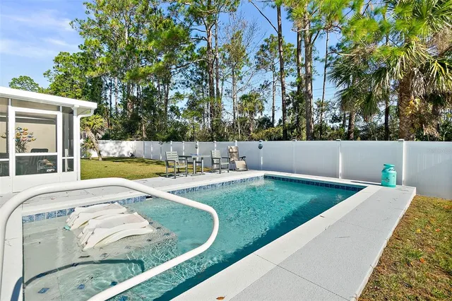 a view of swimming pool with a yard