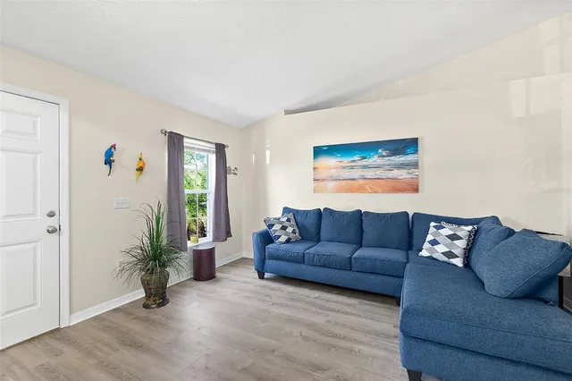 a living room with furniture and a potted plant