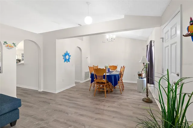 a view of a dining room with furniture and a potted plant