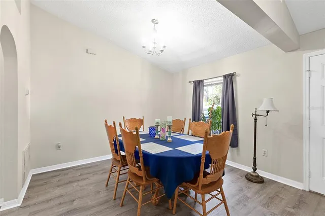 a view of a dining room with furniture and wooden floor