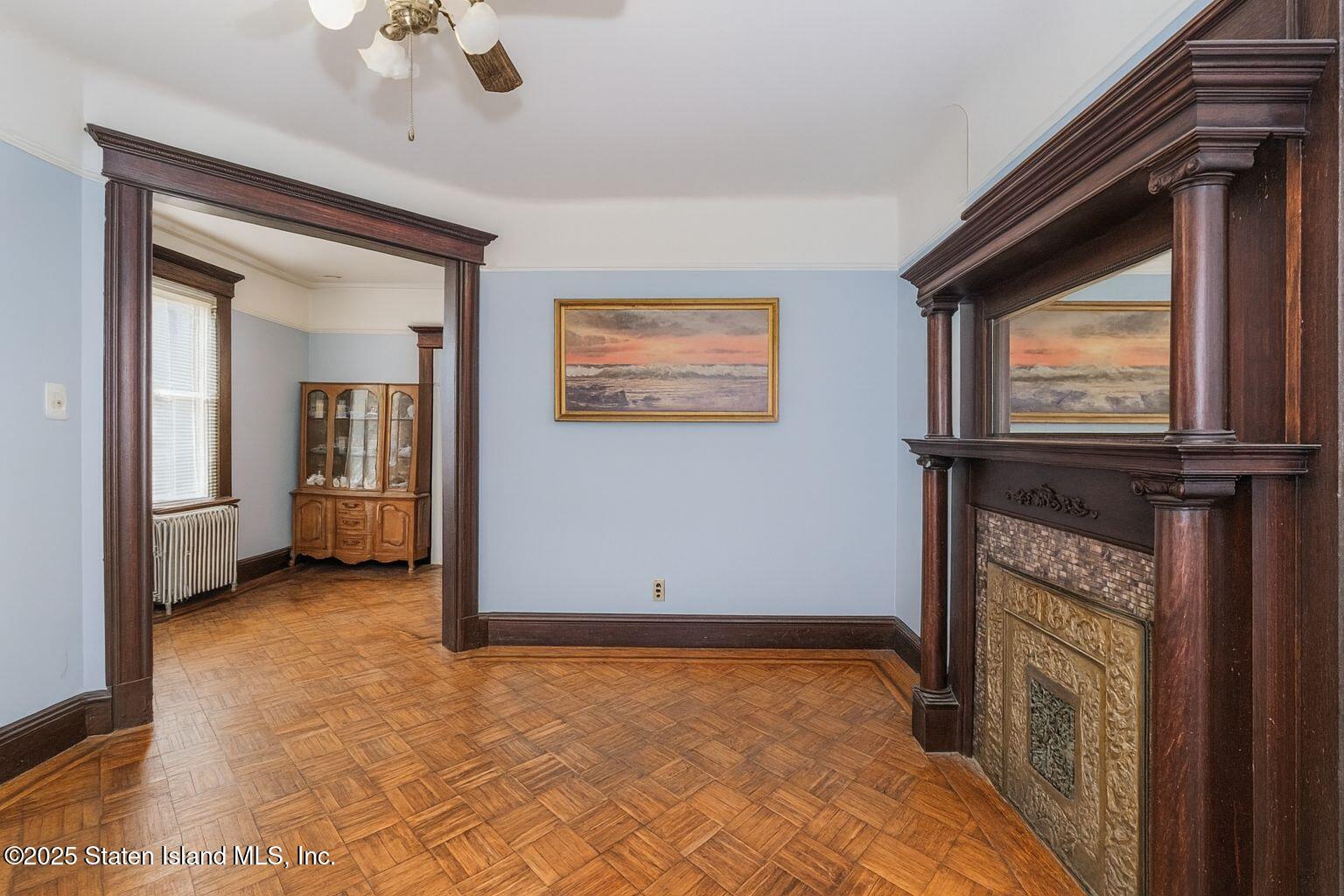 316 Sherman Street Brooklyn, NY 11218 - Photo 11 of 26 a view of an empty room with a fireplace