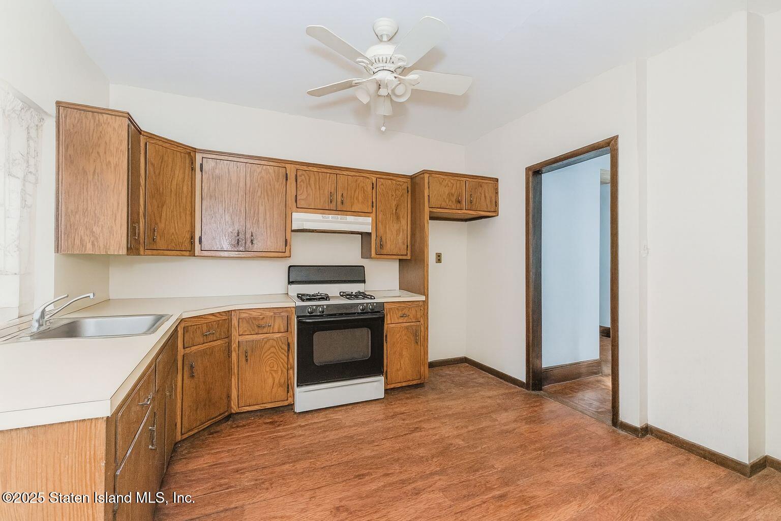 316 Sherman Street Brooklyn, NY 11218 - Photo 12 of 26 a kitchen with stainless steel appliances granite countertop a sink stove and refrigerator