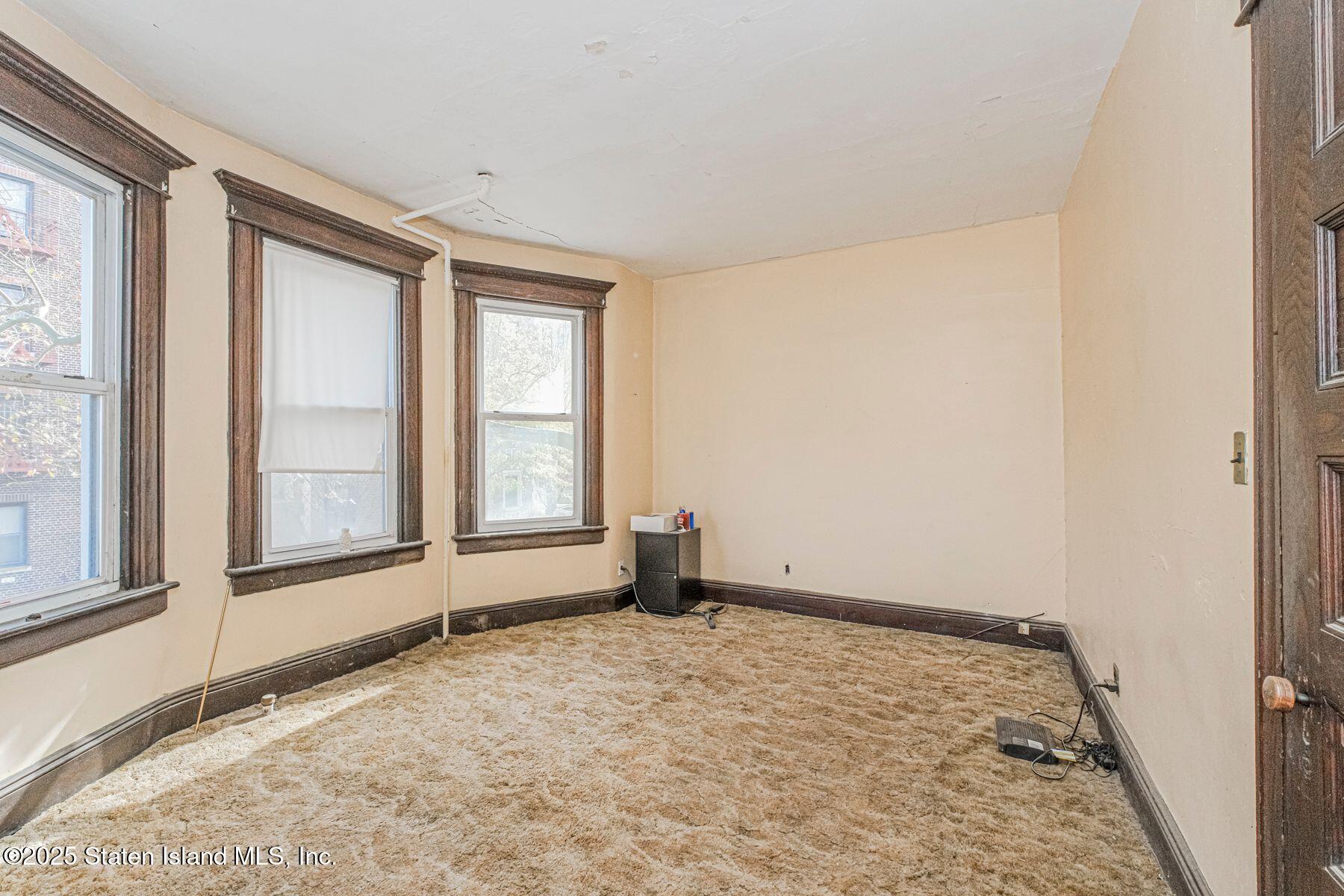 316 Sherman Street Brooklyn, NY 11218 - Photo 19 of 26 an empty room with a window