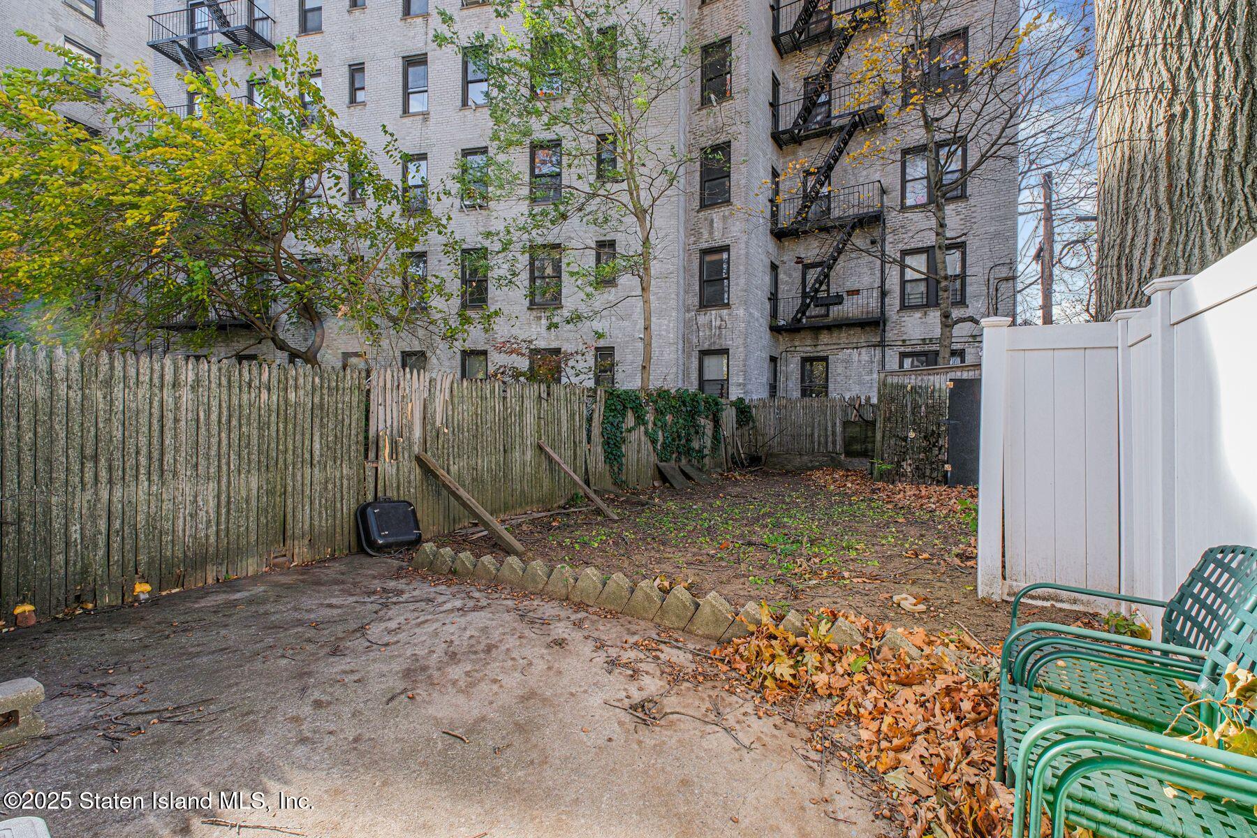 316 Sherman Street Brooklyn, NY 11218 - Photo 25 of 26 a view of a backyard with brick wall and potted plants