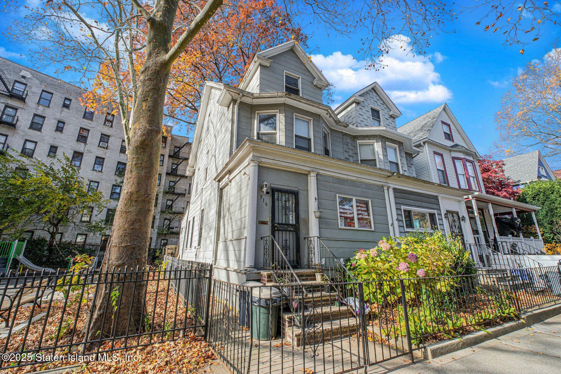 316 Sherman Street Brooklyn, NY 11218 - Photo 3 of 26 front view of a brick house with large windows