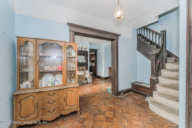 a view of an entryway with wooden floor and a front door