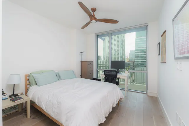 a bedroom with a bed a table and chair