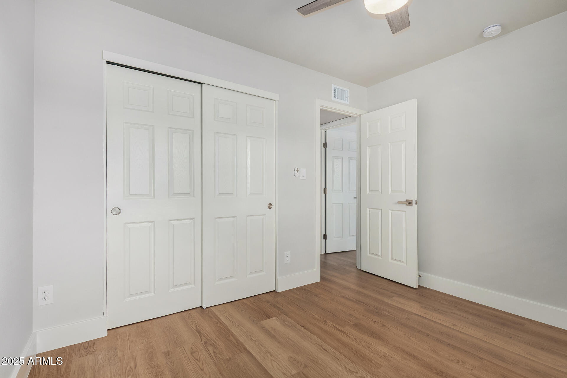 6027 North Granite Reef Road Scottsdale, AZ 85250 - Photo 13 of 29 a view of an empty room with wooden floor